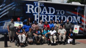 ADA 25th Anniversary group image in front of Road to Freedom ADA25 Tour bus
