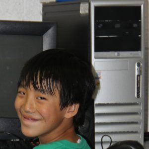 Happy Asian Boy Receives ReBoot Computer